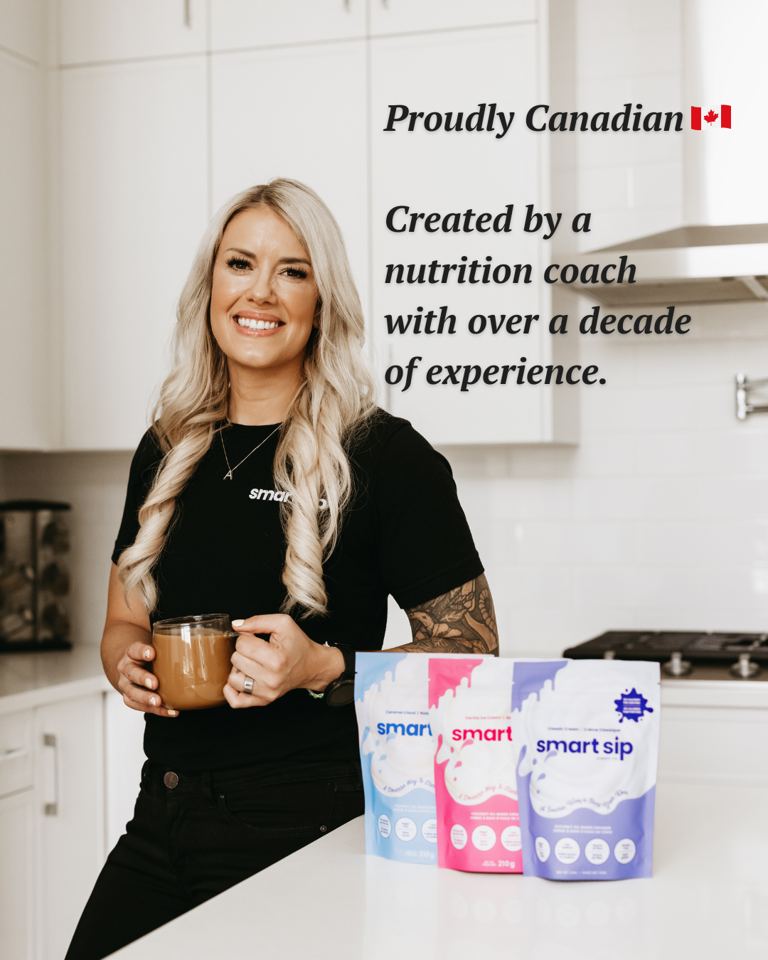 A woman with blonde hair stands in a bright kitchen holding a glass of iced coffee, wearing a black t-shirt with the 'smart sip' logo. Three stand-up pouches of 'smart sip' powdered creamer are lined up on the white countertop in front of her. Text says Proudly Canadian created by a nutrition coach with over a decade of experience.